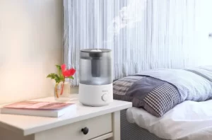 A humidifier on a bedside table in the bedroom